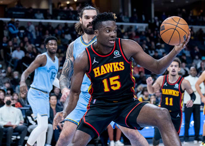 Hawks center Clint Capela rebounds the ball in front of Grizzlies center Steven Adams.