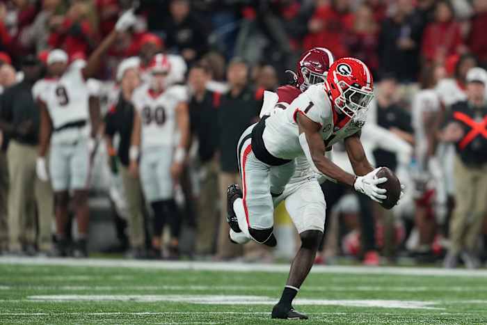 Jan 10, 2022; Indianapolis, IN, USA; Georgia Bulldogs wide receiver George Pickens (right) catches a 52 yard pass against Alabama Crimson Tide defensive back Kool-Aid McKinstry (left) during the first quarter of the 2022 CFP college football national championship game at Lucas Oil Stadium. Mandatory Credit: Kirby Lee-USA TODAY Sports