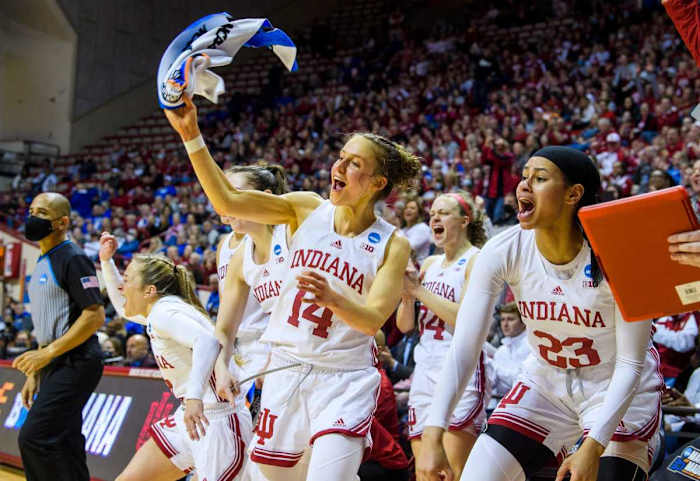 Ali Patberg waves a towel with excitement on the bench.