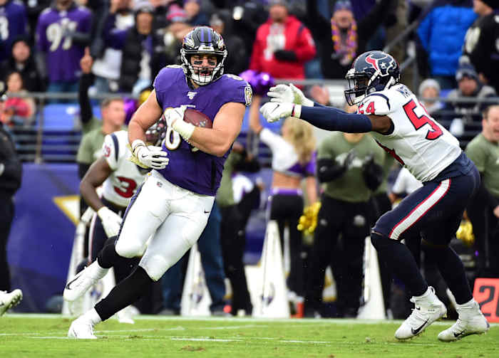Houston Texans EDGE Jacob Martin tries to tackle Baltimore Ravens TE Mark Andrews