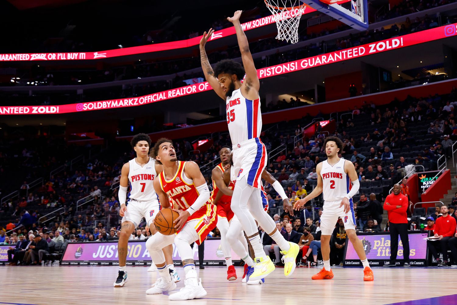 Mar 23, 2022; Detroit, Michigan, USA; Atlanta Hawks guard Trae Young (11) is defended by Detroit Pistons forward Marvin Bagley III (35) in the first half at Little Caesars Arena.