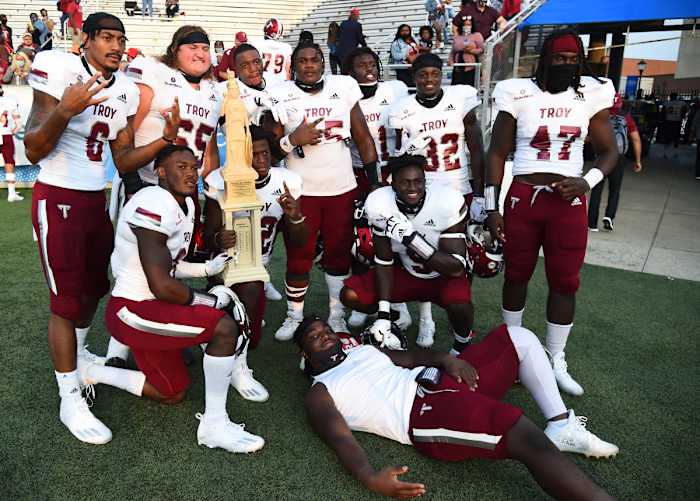 Sep 19, 2020; Murfreesboro, Tennessee, USA; Troy Trojans players celebrate with the Battle for the Palladium traveling trophy after a win over the Middle Tennessee Blue Raiders at Floyd Stadium. Mandatory Credit: Christopher Hanewinckel-USA TODAY Sports