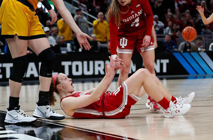 Grace Berger lays on the ground in disbelief.