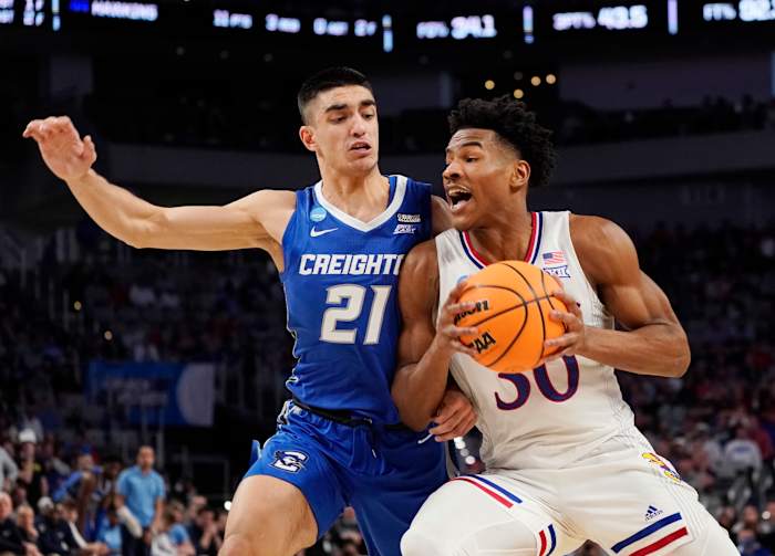 Mar 19, 2022; Fort Worth, TX, USA; Kansas Jayhawks guard Ochai Agbaji (30) drives against Creighton Bluejays guard Rati Andronikashvili (21) during the second round of the 2022 NCAA Tournament at Dickies Arena. Mandatory Credit: Chris Jones-USA TODAY Sports