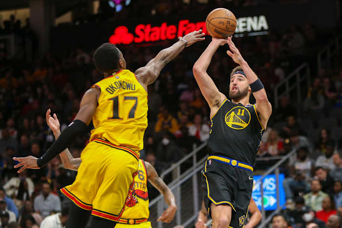 Mar 25, 2022; Atlanta, Georgia, USA; Golden State Warriors guard Klay Thompson (11) shoots over Atlanta Hawks forward Onyeka Okongwu (17) in the second quarter at State Farm Arena.