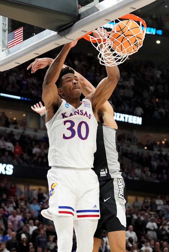 Mar 25, 2022; Chicago, IL, USA; Kansas Jayhawks guard Ochai Agbaji (30) dunks during the second half against the Providence Friars in the semifinals of the Midwest regional of the men's college basketball NCAA Tournament at United Center. Mandatory Credit: David Banks-USA TODAY Sports