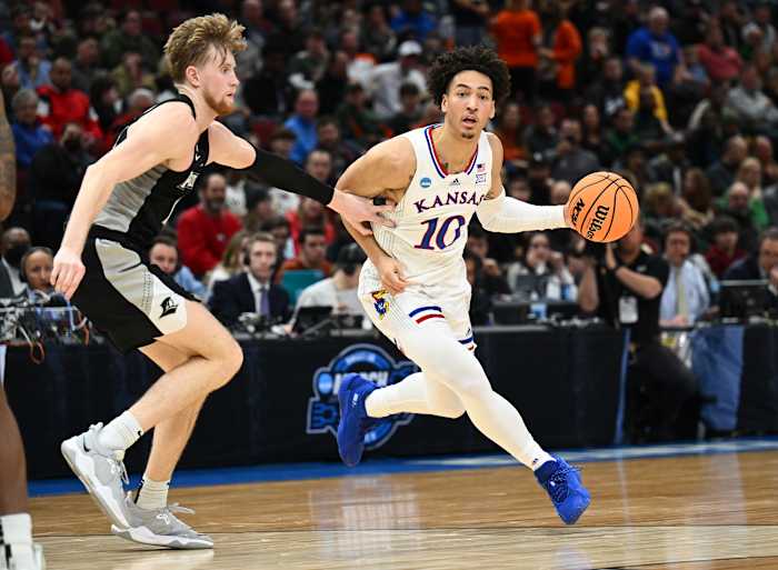 Mar 25, 2022; Chicago, IL, USA; Kansas Jayhawks forward Jalen Wilson (10) dribbles against Providence Friars forward Noah Horchler (14) during the first half in the semifinals of the Midwest regional of the men's college basketball NCAA Tournament at United Center. Mandatory Credit: Jamie Sabau-USA TODAY Sports
