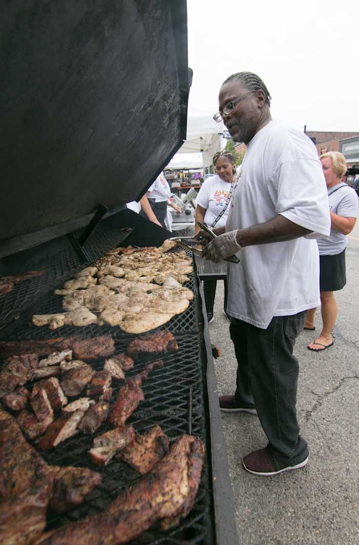 J.B. from Chicago, as he calls himself, checks the chicken at D's & C's Barbecue out of Lansing at the Smokin' Jazz and Barbecue Blues Festival Friday, Sept. 6, 2019. Smokin Jazz Bbq Blues 19 04