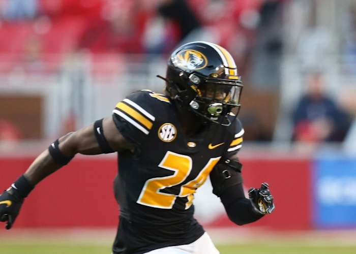 Nov 26, 2021; Fayetteville, Arkansas, USA; Arkansas Razorbacks wide receiver De'Vion Warren (10) runs after a catch as Missouri Tigers defensive back Allie Green IV (24) defends in the third quarter at Donald W. Reynolds Razorbacks Stadium. Arkansas won 34-17. Mandatory Credit: Nelson Chenault-USA TODAY Sports