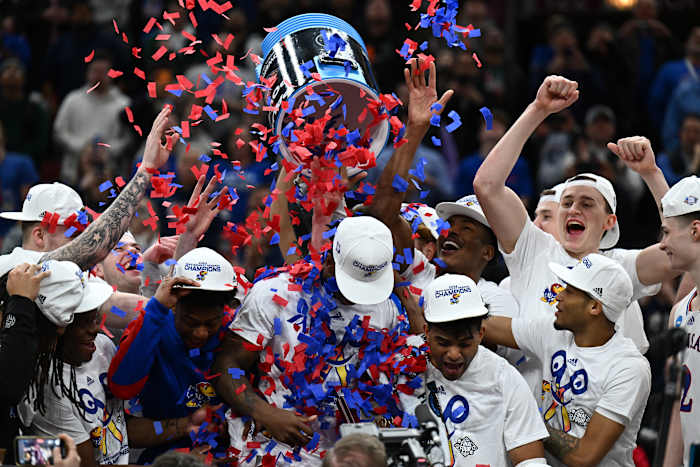 Mar 27, 2022; Chicago, IL, USA; Kansas Jayhawks players celebrate after advancing to the Final Four by defeating the Miami Hurricanes 76-50 in the finals of the Midwest regional of the men's college basketball NCAA Tournament at United Center.