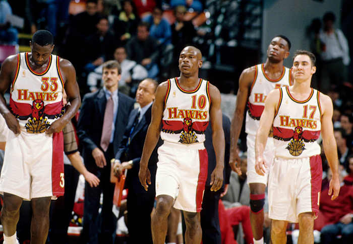 Feb 14, 1997; Atlanta, GA, USA; FILE PHOTO; Atlanta Hawks guard Mookie Blaylock (10), Tyrone Corbin (33), Jon Barry (17) and Dikembe Mutombo (55) against the Chicago Bulls at the Omni.
