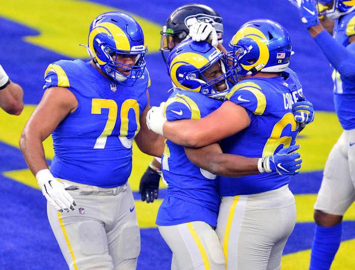 Nov 15, 2020; Inglewood, California, USA; Los Angeles Rams running back Malcolm Brown (34) celebrates with offensive guard Austin Corbett (63) and offensive guard Joe Noteboom (70) his touchdown scored against the Seattle Seahawks during the second half at SoFi Stadium.