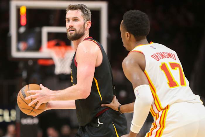 Mar 31, 2022; Atlanta, Georgia, USA; Cleveland Cavaliers forward Kevin Love (0) is defended by Atlanta Hawks forward Onyeka Okongwu (17) in the second quarter at State Farm Arena.