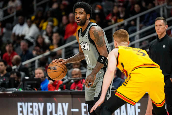 Apr 2, 2022; Atlanta, Georgia, USA; Brooklyn Nets guard Kyrie Irving (11) dribbles guarded by Atlanta Hawks guard Kevin Huerter (3) during the first half at State Farm Arena.