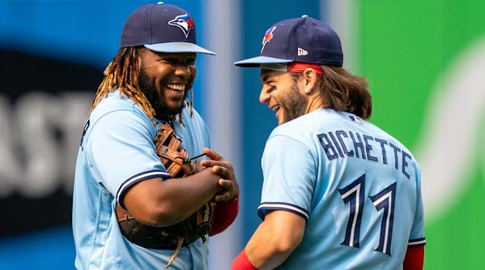 Jul 31, 2021; Toronto, Ontario, CAN; Toronto Blue Jays designated hitter Vladimir Guerrero Jr. (27) and shortstop Bo Bichette (11) have a laugh at Rogers Centre.