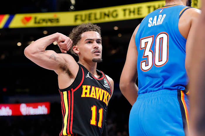 Mar 30, 2022; Oklahoma City, Oklahoma, USA; Atlanta Hawks guard Trae Young (11) gestures towards Oklahoma City Thunder center Olivier Sarr (30) after scoring a basket during the first half at Paycom Center.