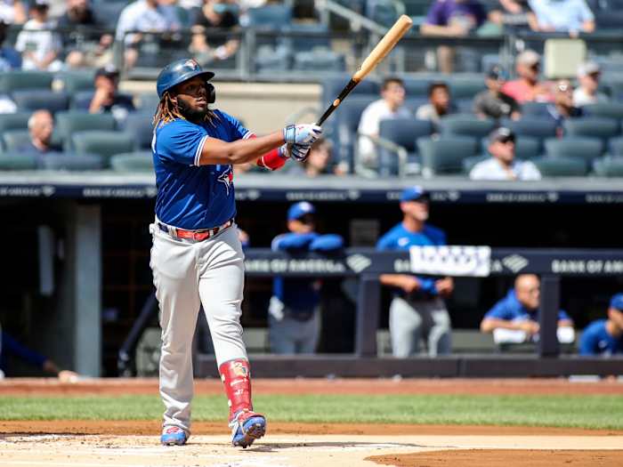 Sep 6, 2021; Bronx, New York, USA; Toronto Blue Jays first baseman Vladimir Guerrero Jr. (27) hits a solo home run in the first inning against the New York Yankees at Yankee Stadium.