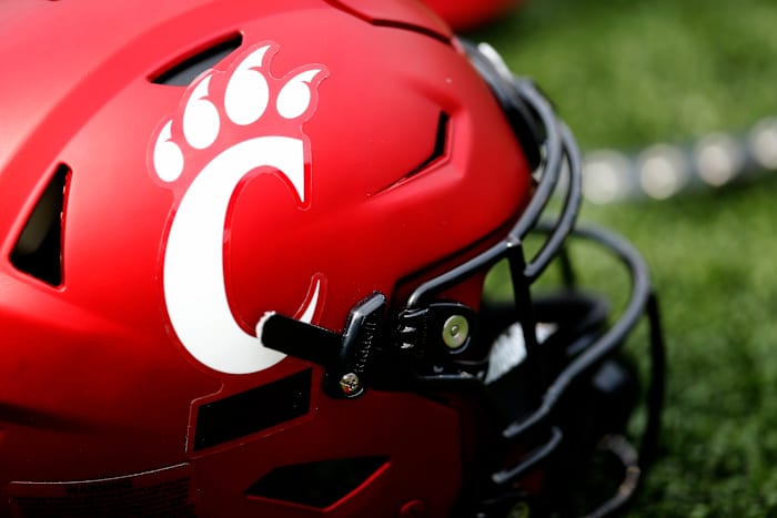 A Cincinnati Bearcats helmet lays on the turf during a spring practice at Nippert Stadium in Cincinnati on Thursday, March 24, 2022. Cincinnati Bearcats Spring Practice