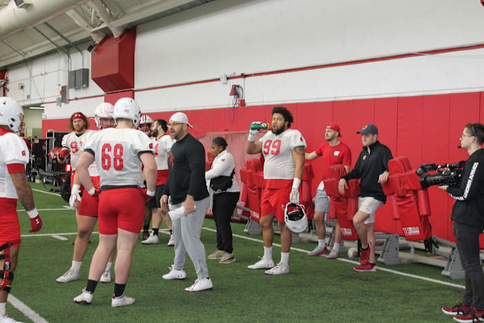 Defensive line coach Ross Kolodziej speaking with his group.