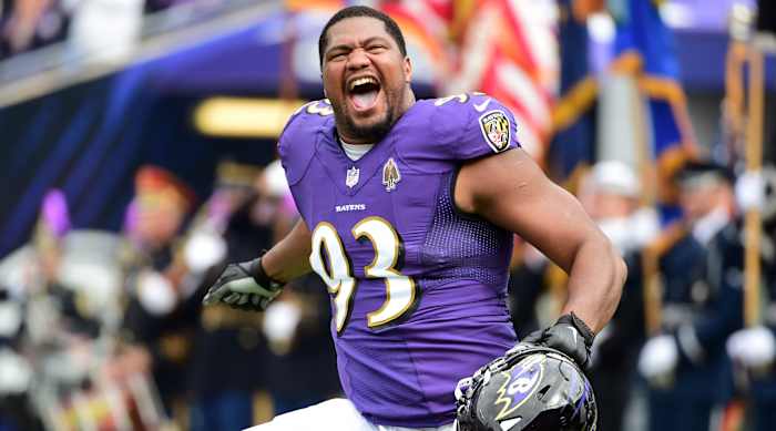 Calais Campbell runs onto the field before a game.