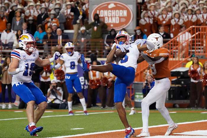 Nov 13, 2021; Austin, Texas, USA; Kansas Jayhawks safety OJ Burroughs (5) intercepts a pass in the end zone intended for Texas Longhorns wide receiver Xavier Worthy (8) in the second half at Darrell K Royal-Texas Memorial Stadium. Mandatory Credit: Scott Wachter-USA TODAY Sports