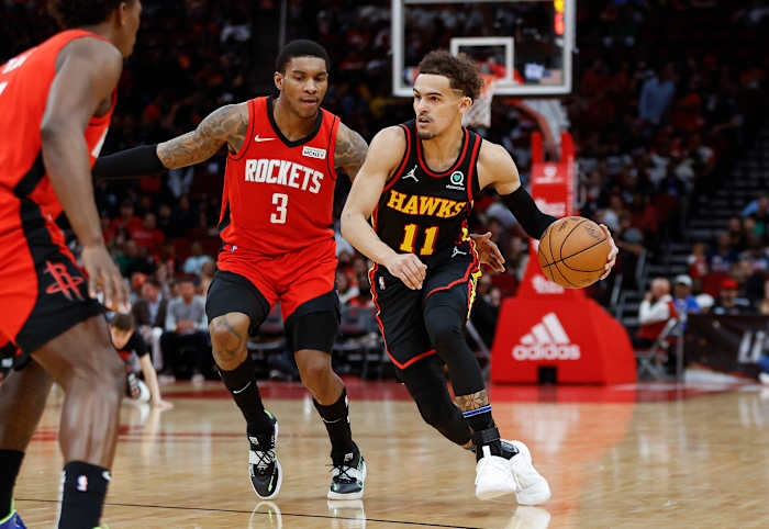 Apr 10, 2022; Houston, Texas, USA; Atlanta Hawks guard Trae Young (11) dribbles the ball as Houston Rockets guard Kevin Porter Jr. (3) defends during the third quarter at Toyota Center.
