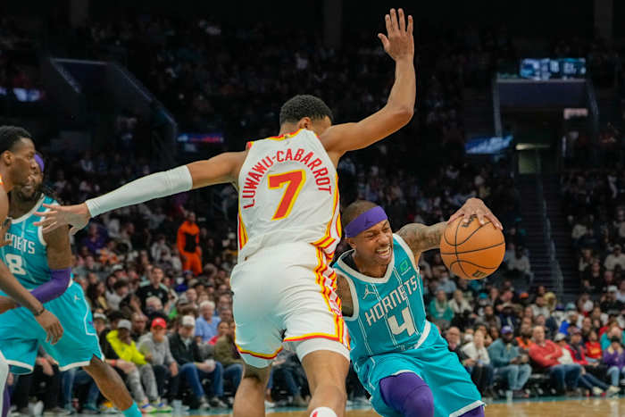 Mar 16, 2022; Charlotte, North Carolina, USA; Charlotte Hornets guard Isaiah Thomas (4) tries to corner around Atlanta Hawks guard Timothe Luwawu-Cabarrot (7) during the second half at the Spectrum Center.