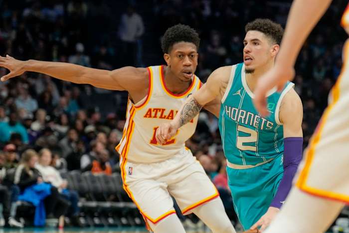 Mar 16, 2022; Charlotte, North Carolina, USA; Charlotte Hornets guard LaMelo Ball (2) drives to the basket against Atlanta Hawks forward De'Andre Hunter (12) during the second half at the Spectrum Center.