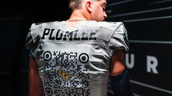 UCF’s John Rhys Plumlee shows off team’s QR code-emblazoned spring jersey.