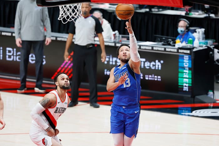 Mar 19, 2021; Portland, Oregon, USA; Dallas Mavericks point guard Jalen Brunson (13) shoots the ball past Portland Trail Blazers shooting guard Gary Trent Jr. (2) during the first half at Moda Center.