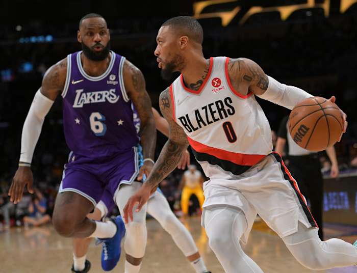 Dec 31, 2021; Los Angeles, California, USA; Portland Trail Blazers guard Damian Lillard (0) drives past Los Angeles Lakers forward LeBron James (6) in the first quarter at Crypto.com Arena. Mandatory Credit: Jayne Kamin-Oncea-USA TODAY Sports