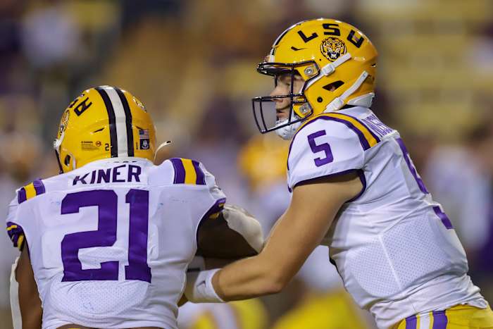 Sep 11, 2021; Baton Rouge, Louisiana, USA; LSU Tigers quarterback Garrett Nussmeier (5) hands the ball off to running back Corey Kiner (21) against the McNeese State Cowboys during the second half at Tiger Stadium. Mandatory Credit: Stephen Lew-USA TODAY Sports