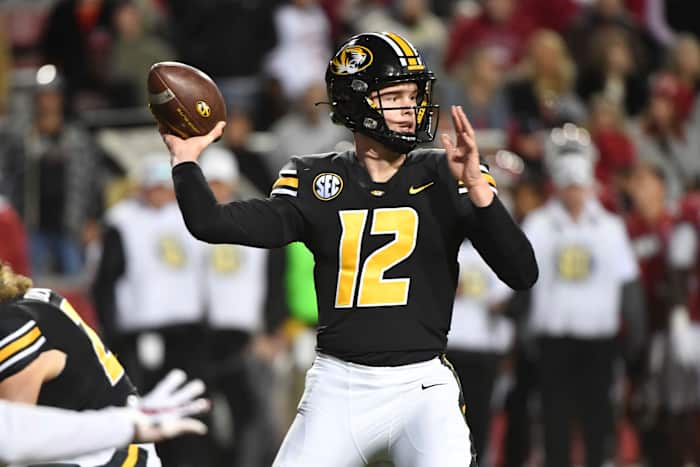 Missouri quarterback Brady Cook (12) throws the ball against Arkansas during an NCAA college football game Friday, Nov. 26, 2021, in Fayetteville, Ark. (AP Photo/Michael Woods)