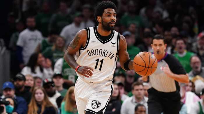 Brooklyn Nets guard Kyrie Irving (11) returns the ball against the Boston Celtics.