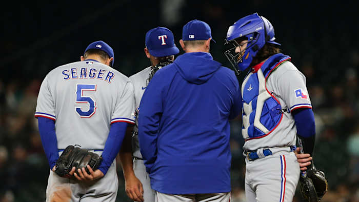 Apr 20, 2022; Seattle, Washington, USA; Texas Rangers starting pitcher Dane Dunning (33) talks to pitching coach Doug Mathis after giving up a run against the Seattle Mariners during the third inning at T-Mobile Park. Mandatory Credit: Lindsey Wasson-USA TODAY Sports