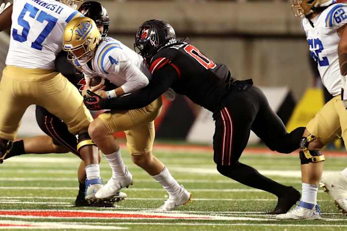 Oct 30, 2021; Salt Lake City, Utah, USA; UCLA Bruins quarterback Ethan Garbers (4) is sacked by Utah Utes linebacker Devin Lloyd (0) during the fourth quarter at Rice-Eccles Stadium. Mandatory Credit: Rob Gray-USA TODAY Sports