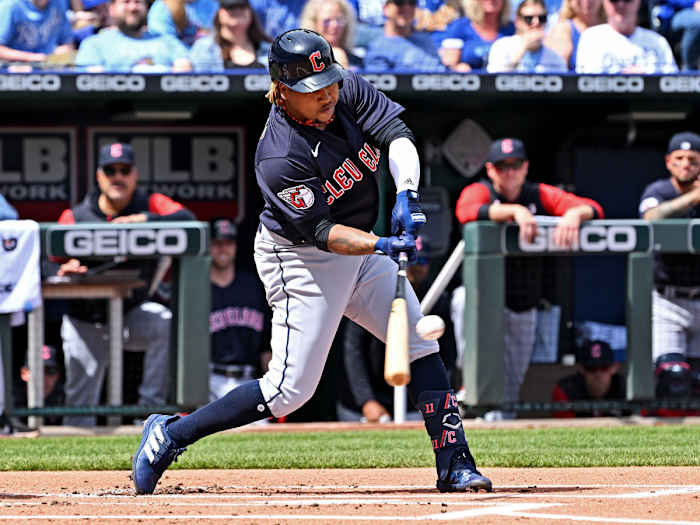 Apr 10, 2022; Kansas City, Missouri, USA; Cleveland Guardians third baseman Jose Ramirez (11) hits an RBI single during the first inning against the Kansas City Royals at Kauffman Stadium.