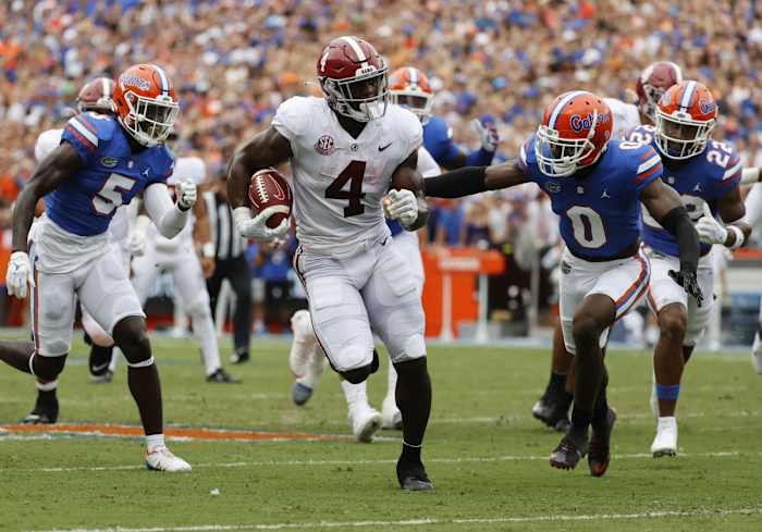 Alabama running back Brian Robinson Jr. (4) runs with the ball as Florida safety Trey Dean III (0) defends. Mandatory Credit: Kim Klement-USA TODAY