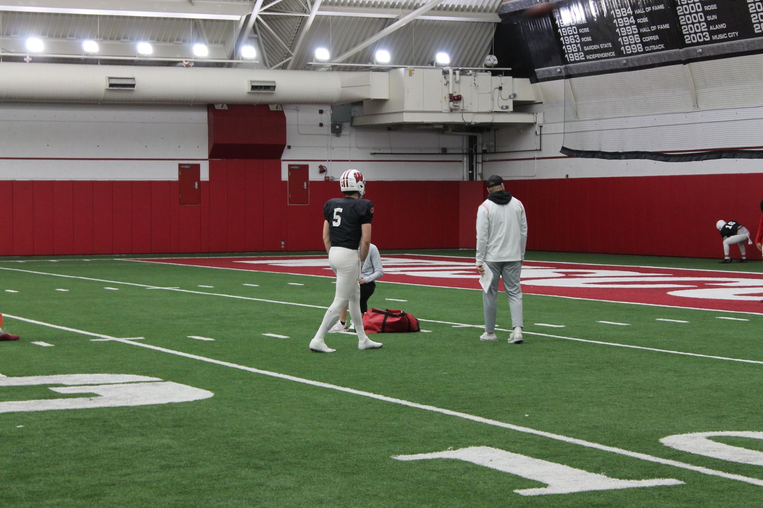 Returning starter Graham Mertz worked closely with graduate assistant Kelly Chryst this spring and new offensive coordinator Bobby Engram.
