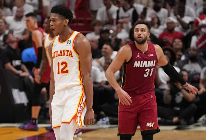 Apr 26, 2022; Miami, Florida, USA; Atlanta Hawks forward De'Andre Hunter (12) reacts after making a three point shot over Miami Heat guard Max Strus (31) during the second half in game five of the first round for the 2022 NBA playoffs at FTX Arena.