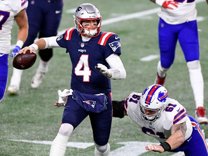Dec 28, 2020; Foxborough, Massachusetts, USA; New England Patriots quarterback Jarrett Stidham (4) looks to pass under pressure from Buffalo Bills defensive tackle Justin Zimmer (61) during the second half at Gillette Stadium. Mandatory Credit: Brian Fluharty-USA TODAY Sports