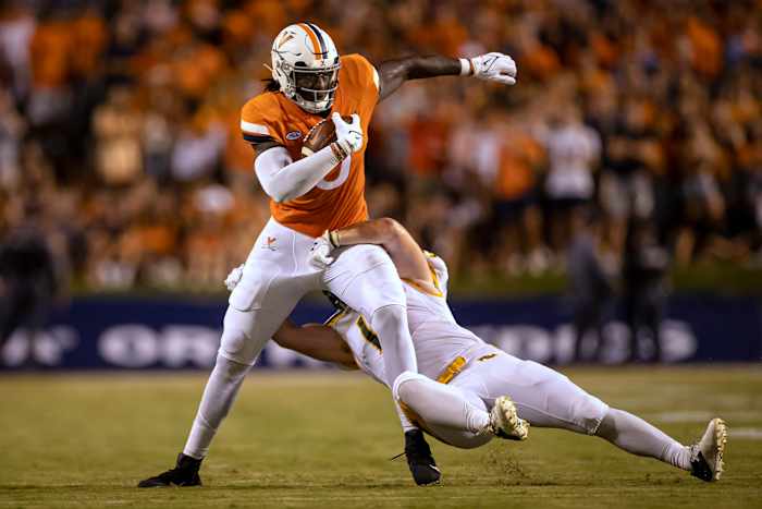 Sep 4, 2021; Charlottesville, Virginia, USA; Virginia Cavaliers tight end Jelani Woods (0) carries the ball against William & Mary Tribe linebacker Kevin Jarrell (19) during the first half at Scott Stadium. Mandatory Credit: Scott Taetsch-USA TODAY Sports