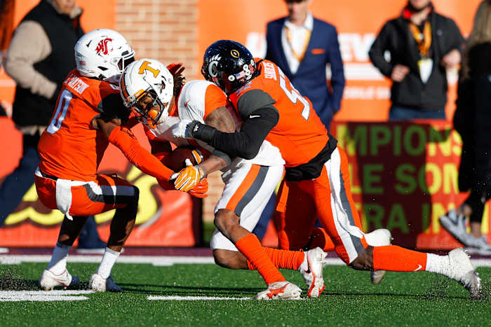 Feb 5, 2022; Mobile, AL, USA; American squad wide receiver Velus Jones Jr. of Tennessee (1) is tackled by National Squad cornerback Jaylen Watson of Washington State (0) and defensive lineman Myjai Sanders of Cincinnati (52) in the second half during the Senior bowl at Hancock Whitney Stadium. Mandatory Credit: Nathan Ray Seebeck-USA TODAY Sports