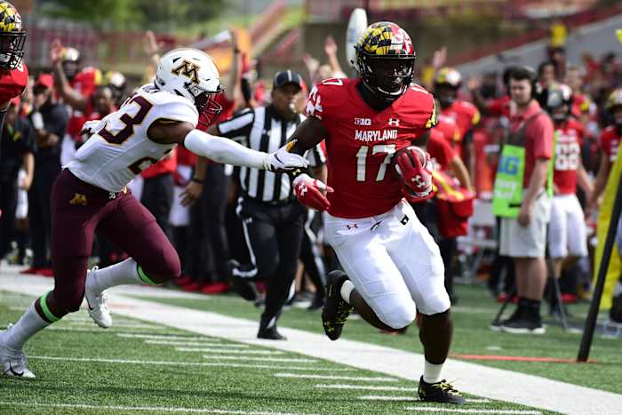 Maryland Terrapins tight end Chigoziem Okonkwo (17) runs pass Minnesota Golden Gophers defensive back Jordan Howden (23) during the fourth quarter at Capital One Field at Maryland Stadium.