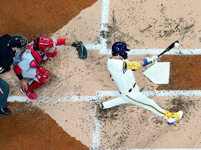 Milwaukee Brewers’ Christian Yelich hits a double during the first inning of a baseball game against the Cincinnati Reds Wednesday, May 4, 2022, in Milwaukee.