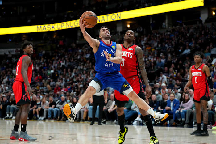 Denver Nuggets guard Facundo Campazzo (7) shoots past Houston Rockets guard Kevin Porter Jr. (3) in the second quarter at Ball Arena.