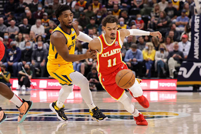 Atlanta Hawks guard Trae Young (11) tries to dribble away from Utah Jazz guard Donovan Mitchell (45) during the first quarter at Vivint Arena.