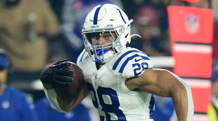 Indianapolis Colts running back Jonathan Taylor runs with the ball.