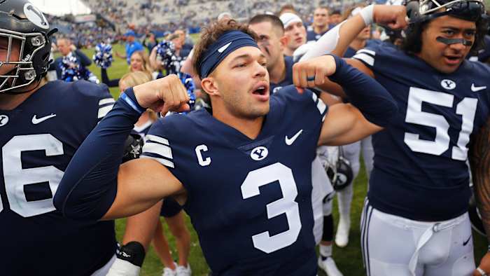 BYU football quarterback Jaren Hall flexes after a win