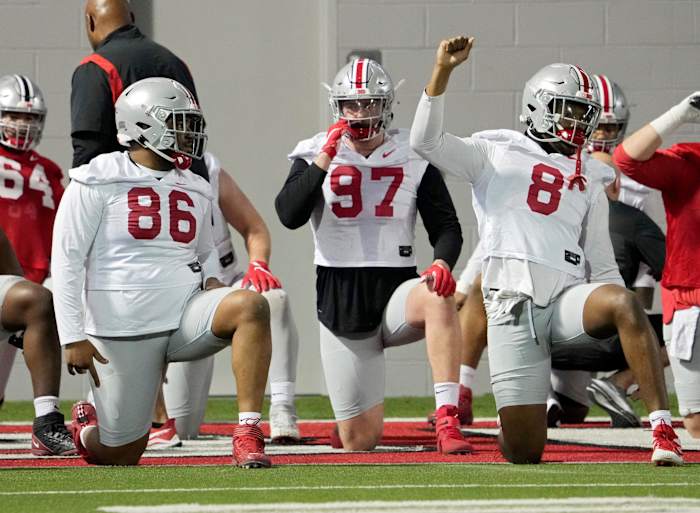 Defensive players Jerron Cage (86), Noah Potter (97) and Javontae Jean-Baptiste (8) stretch during the first practice of spring football for Ohio State University at the Woody Hayes Athletic Center in Columbus on Tuesday, March 8, 2022. Ceb Osufb Spring 0308 Bjp 14